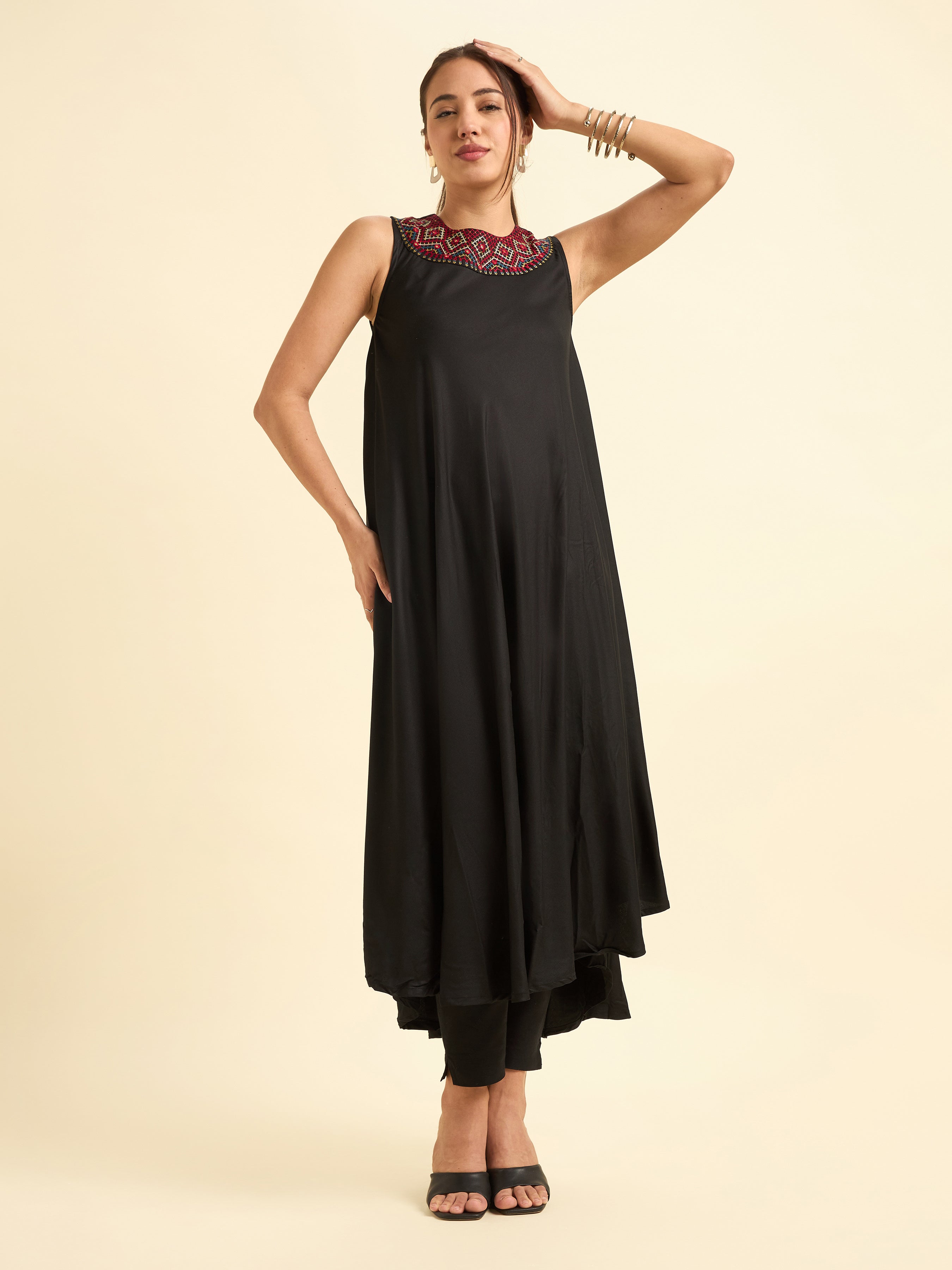 Women Wearing Black Colour Viscose Plain Flared Kurti With Mirror Work Embroidery