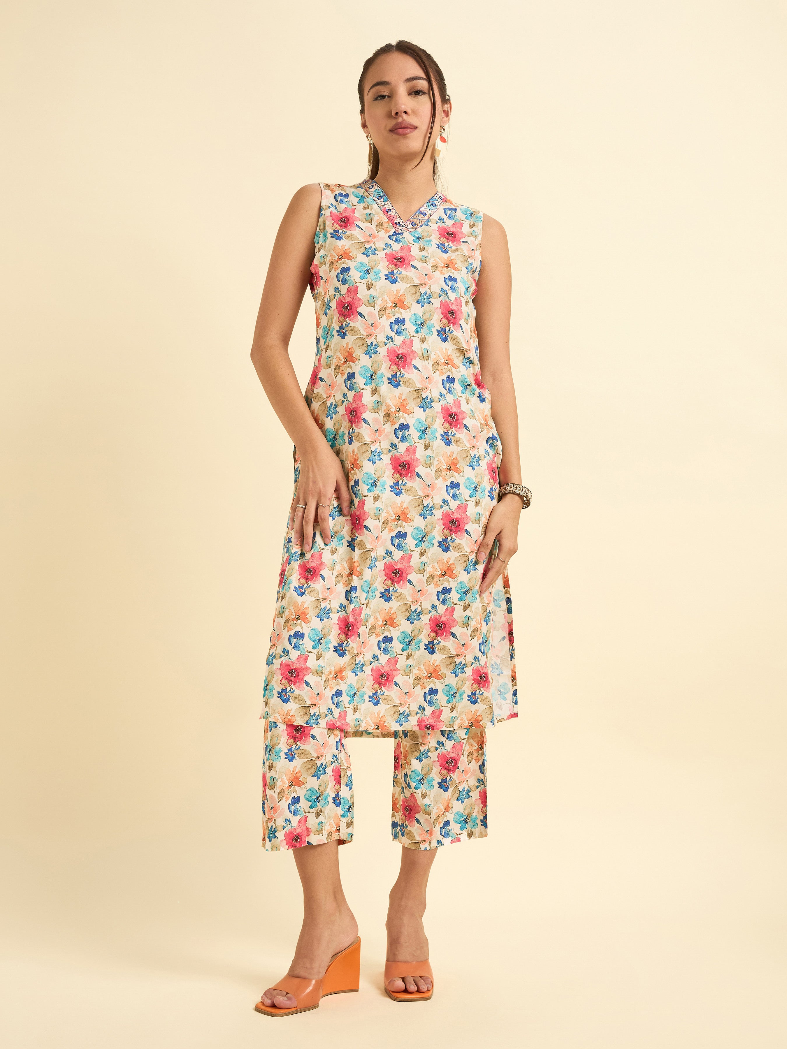 Women Wearing Ivory Multi Colour Cotton Flax Printed Sleeveless Kurti Set With Mirror Work Embroidery