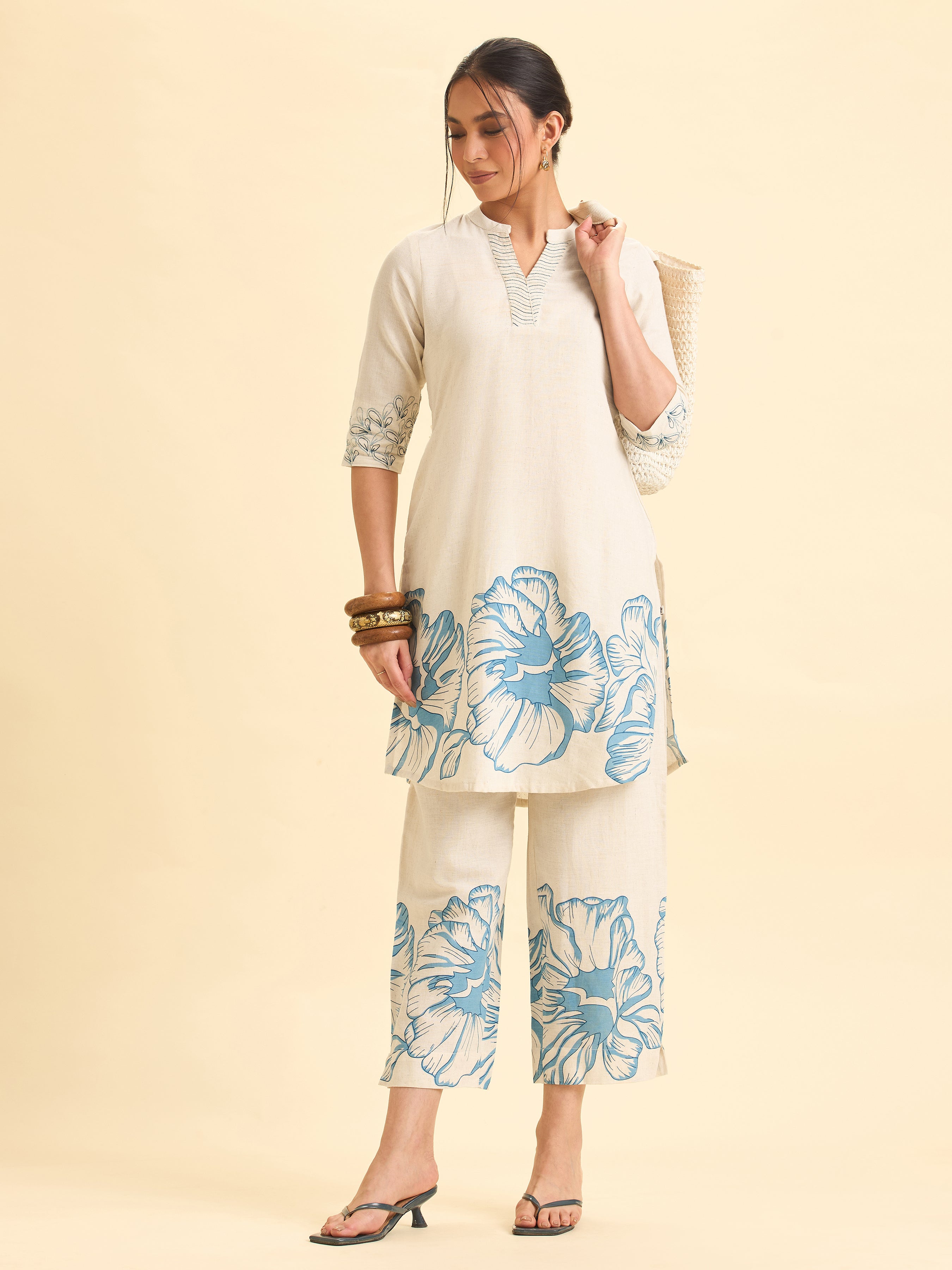 Women Wearing Ivory And Blue Cotton Flax Printed Kurti With Embroidery