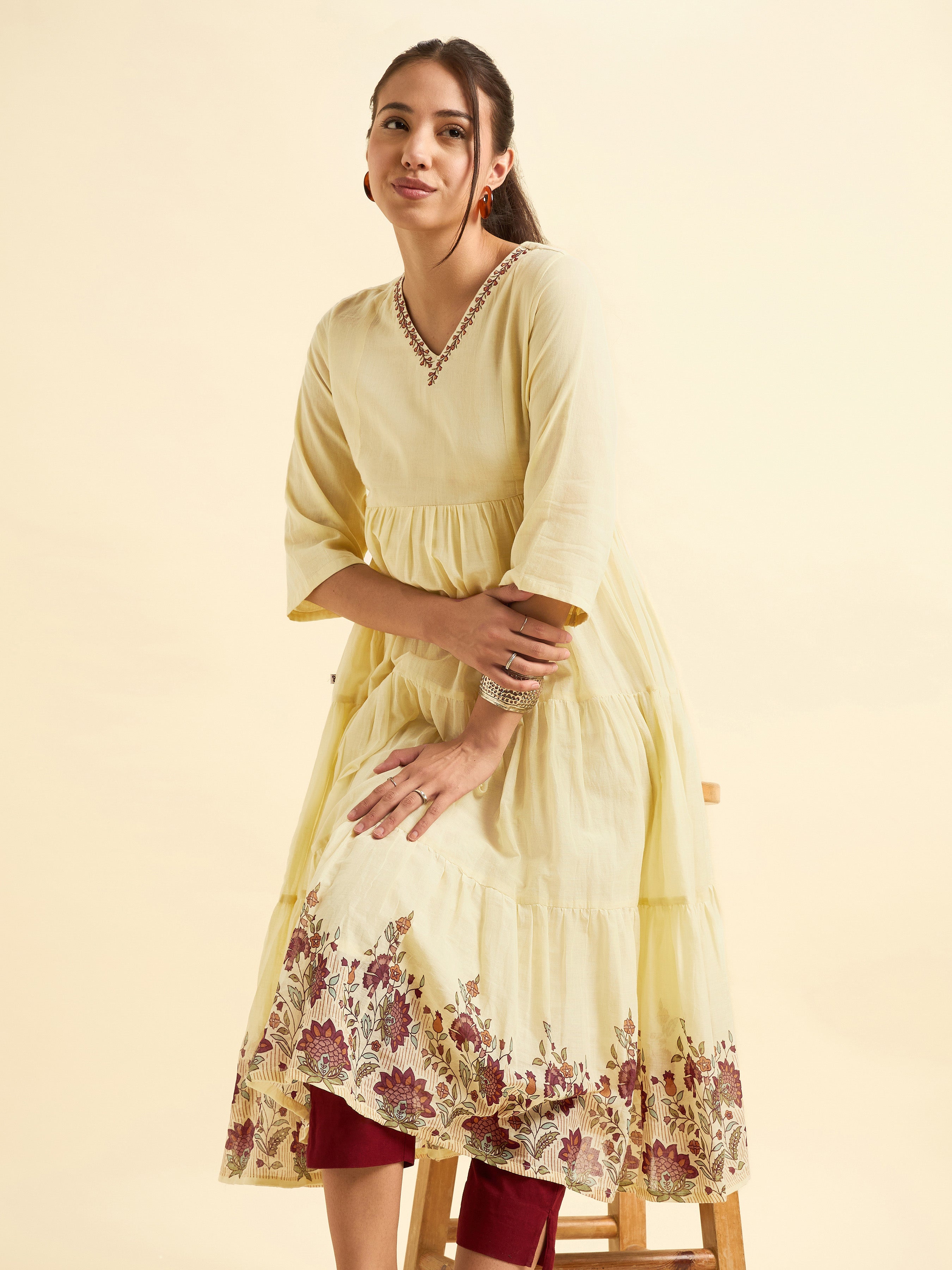 Pale Yellow Pure Cotton Tiered Kurti With Print And Embroidery