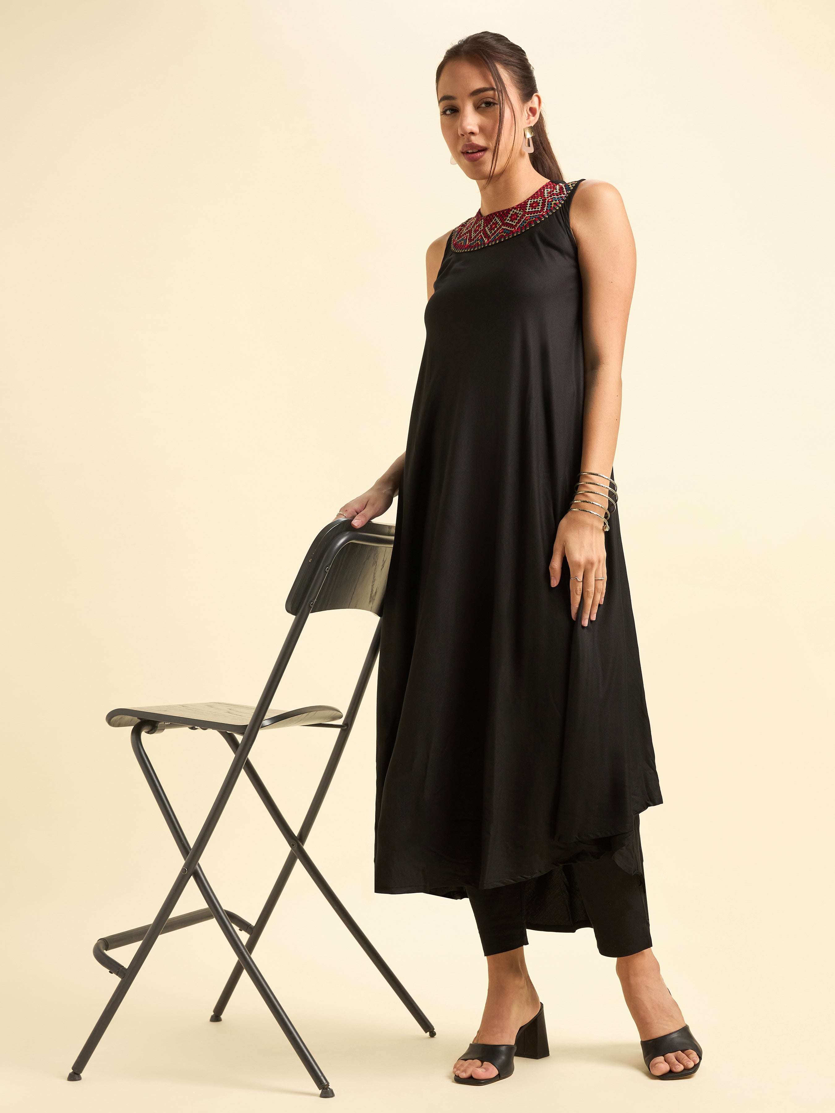 Women Wearing Black Colour Viscose Plain Flared Kurti With Mirror Work Embroidery