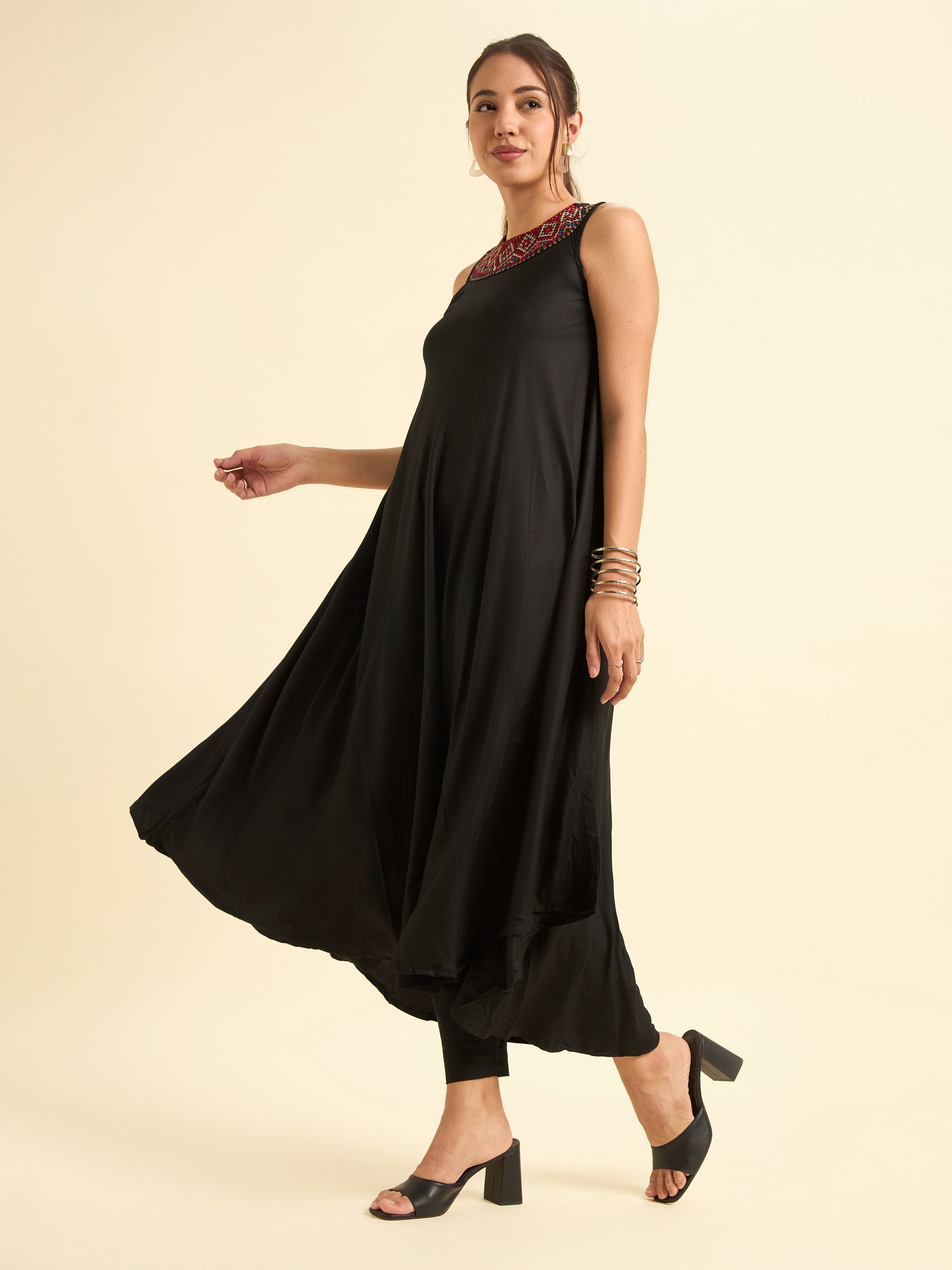 Women Wearing Black Colour Viscose Plain Flared Kurti With Mirror Work Embroidery