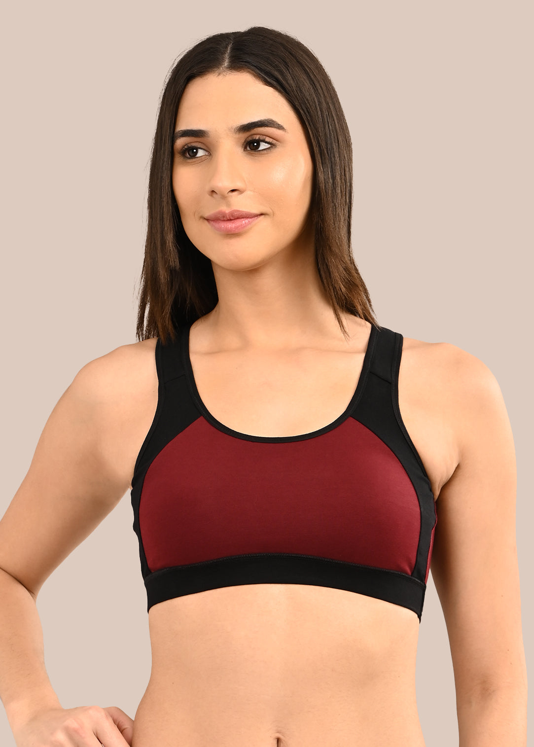 Woman wearing a bra against a neutral background
