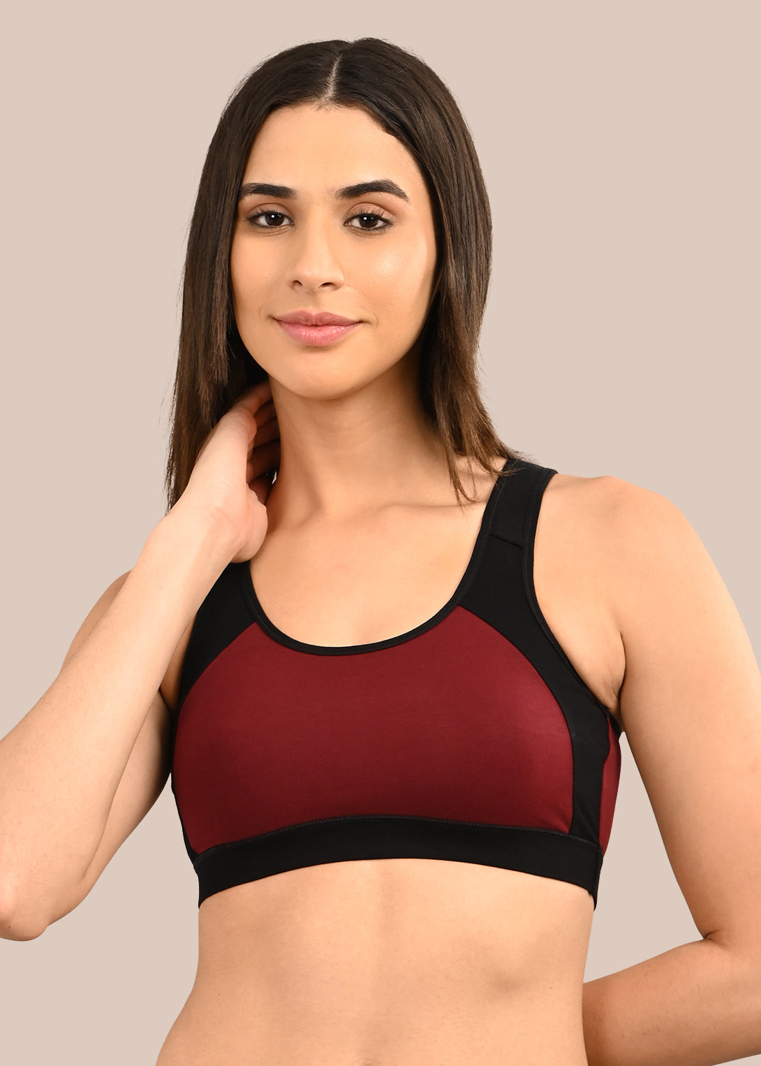 Woman wearing a bra against a neutral background