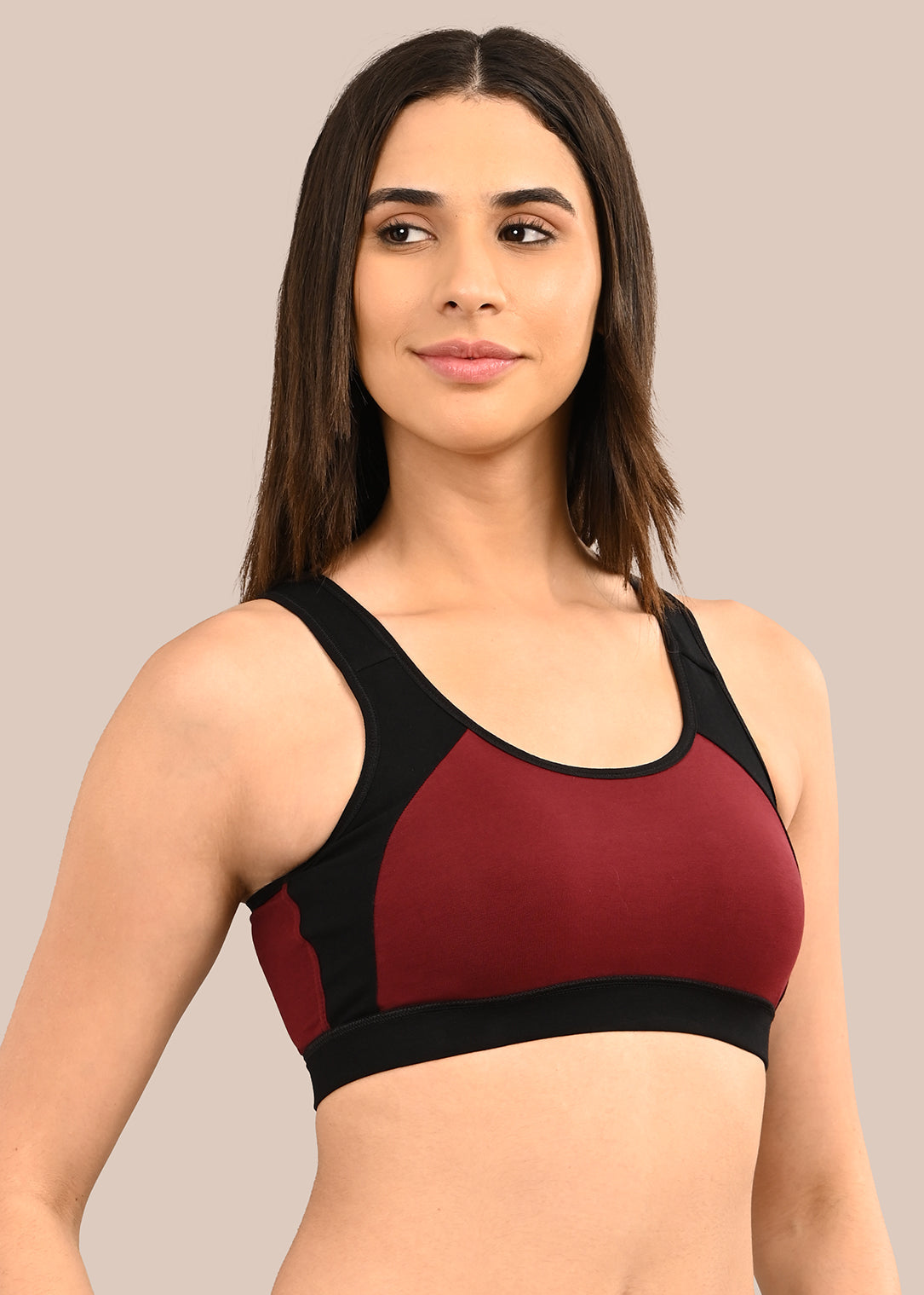 Woman wearing a bra against a neutral background
