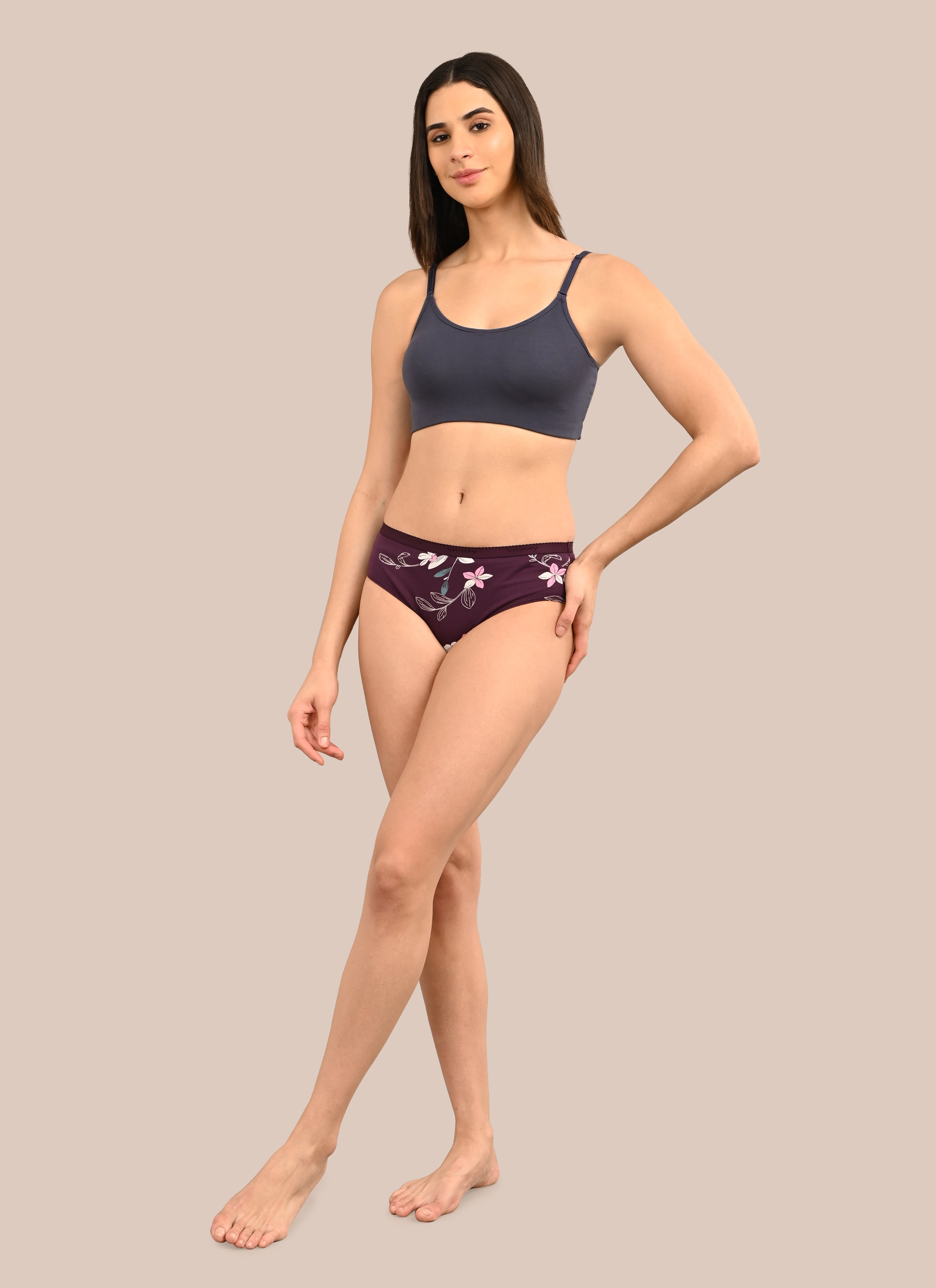 Woman wearing a bra against a neutral background