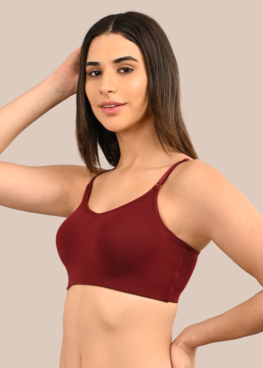 Woman wearing a bra against a neutral background