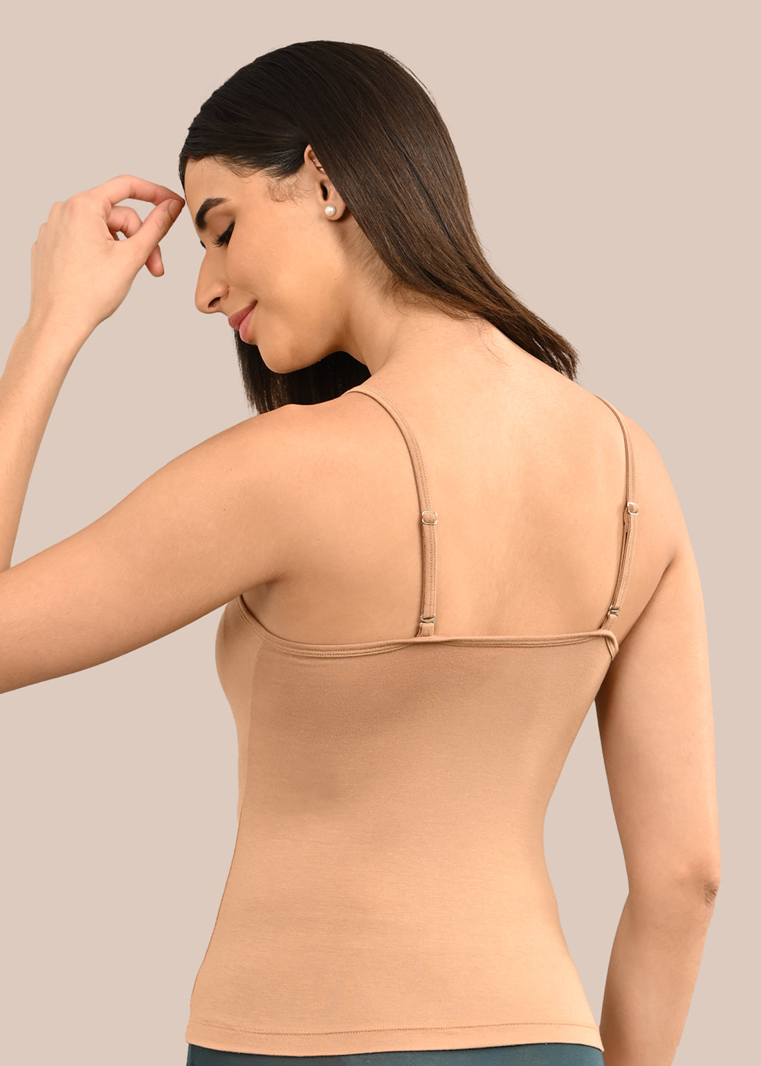 Woman wearing a bra against a neutral background