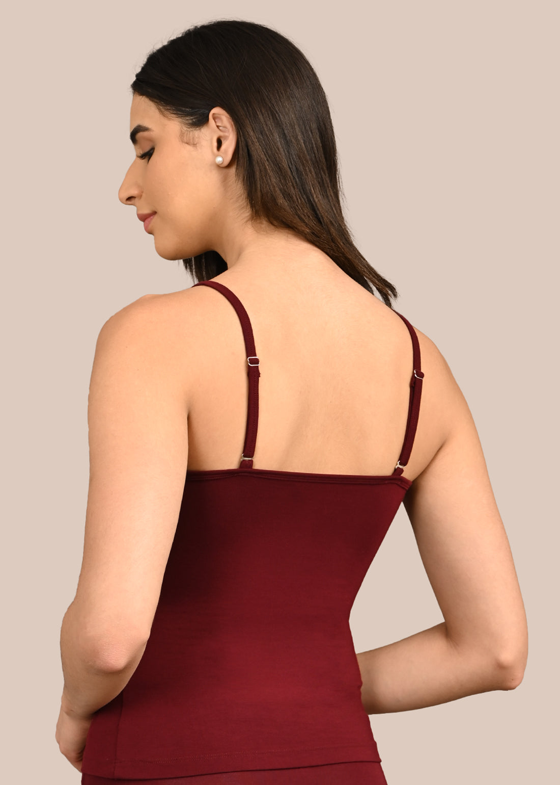 Woman wearing a bra against a neutral background