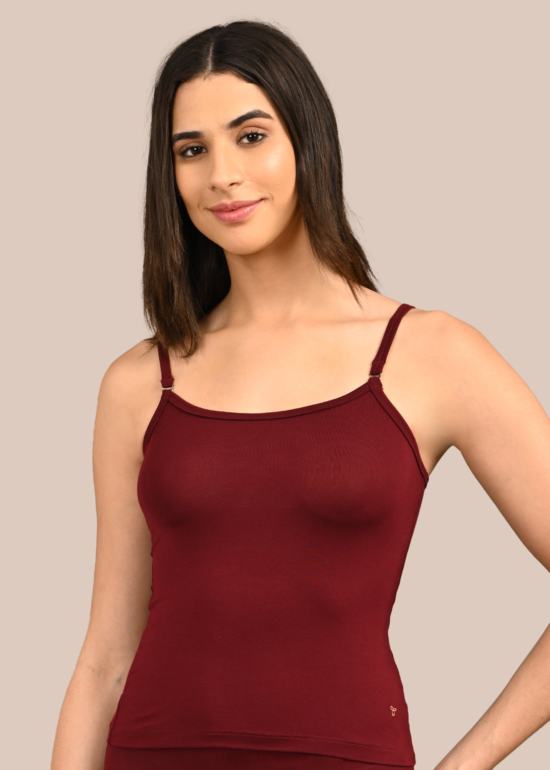 Woman wearing a bra against a neutral background