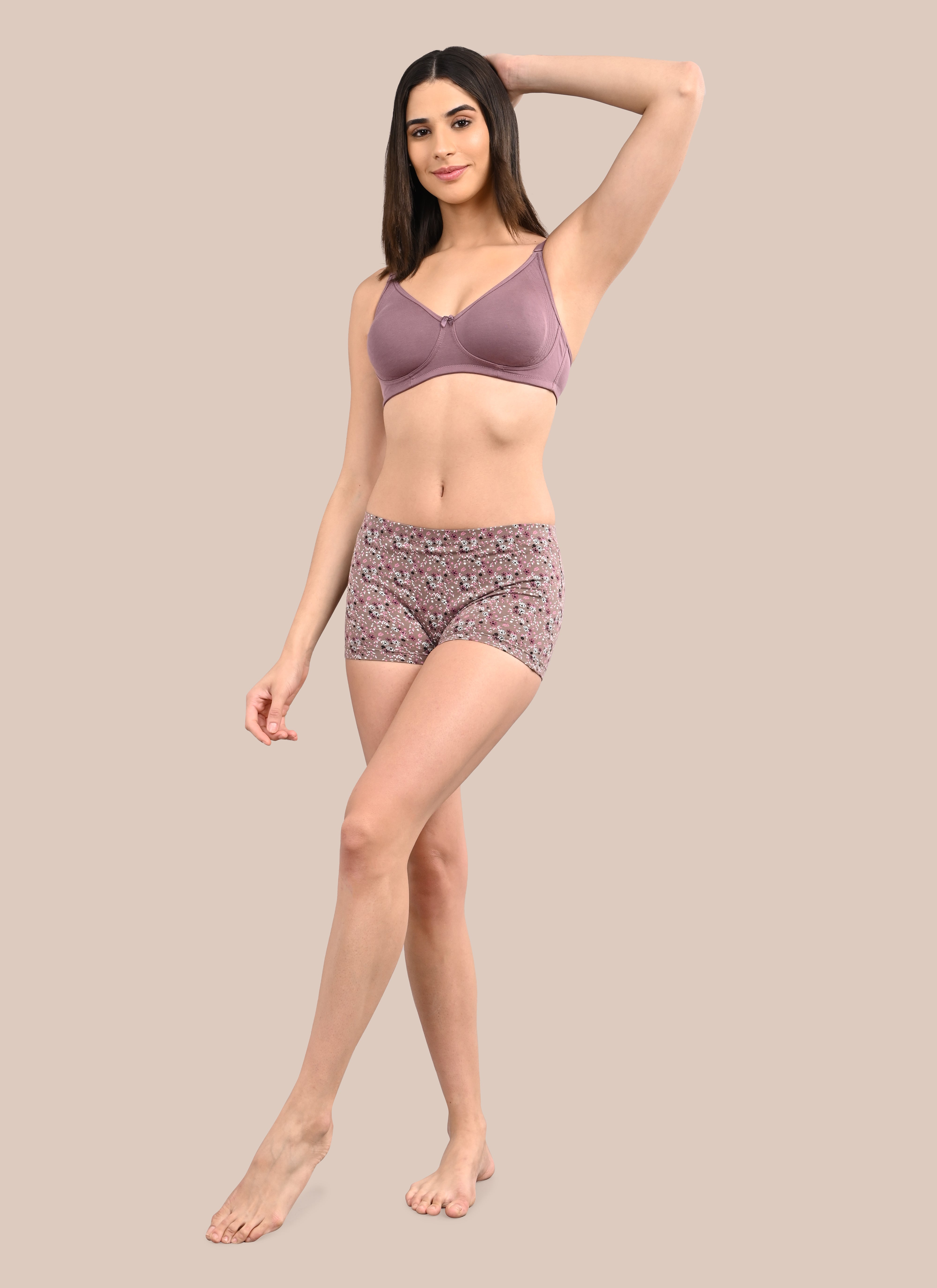 Woman wearing a bra against a neutral background