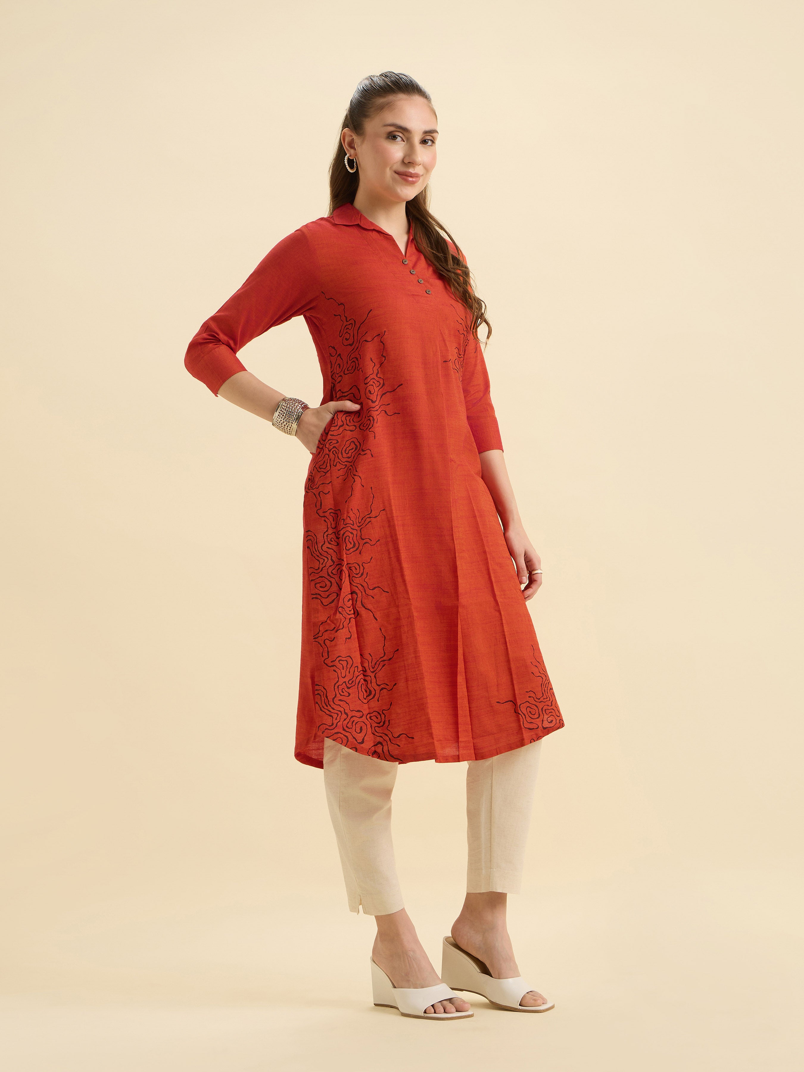 Orange Cotton Viscose Plain Slit Kurti With Placement Print, Knife Pleats & Curved Hemline