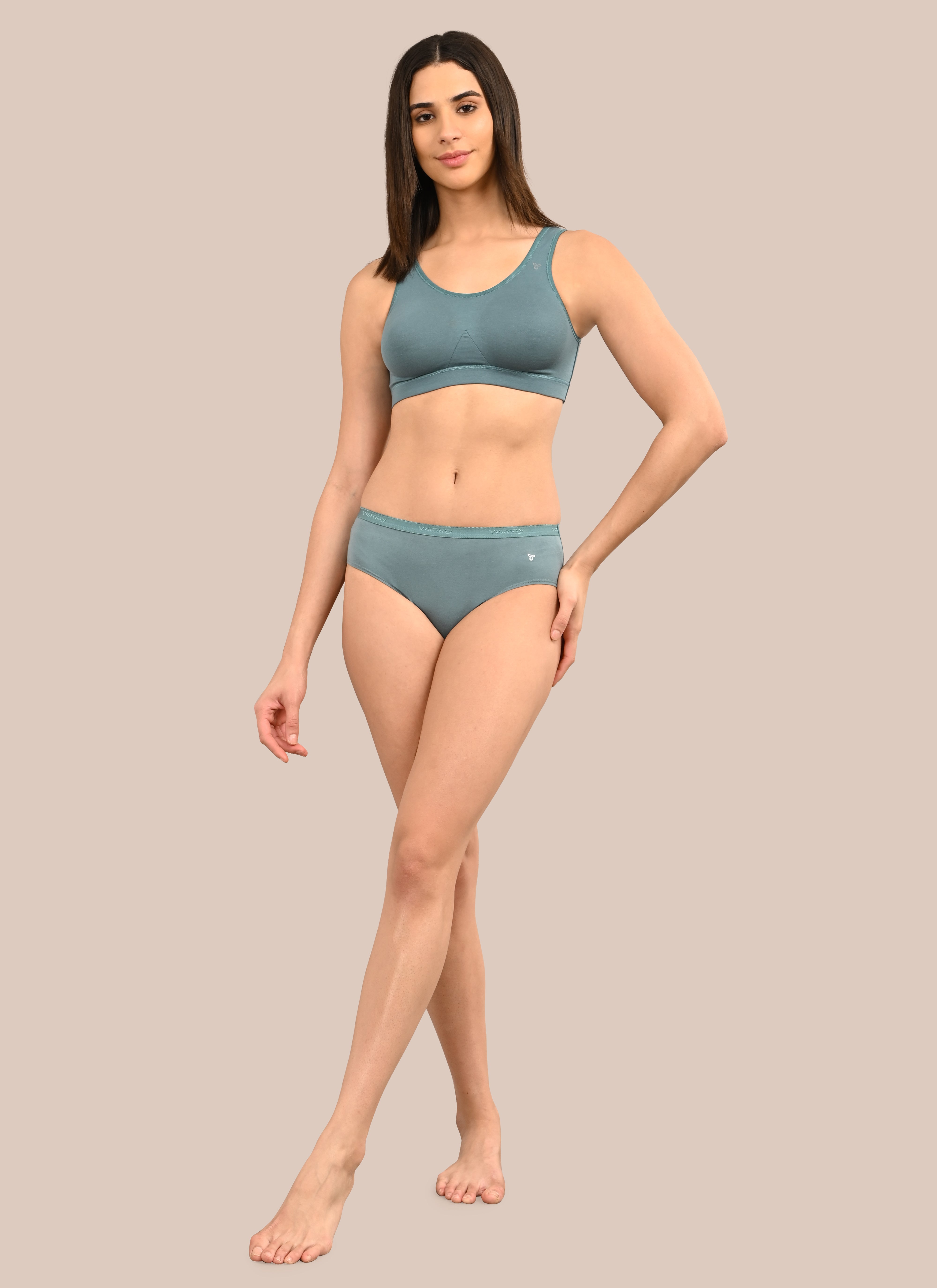 Woman wearing a bra against a neutral background