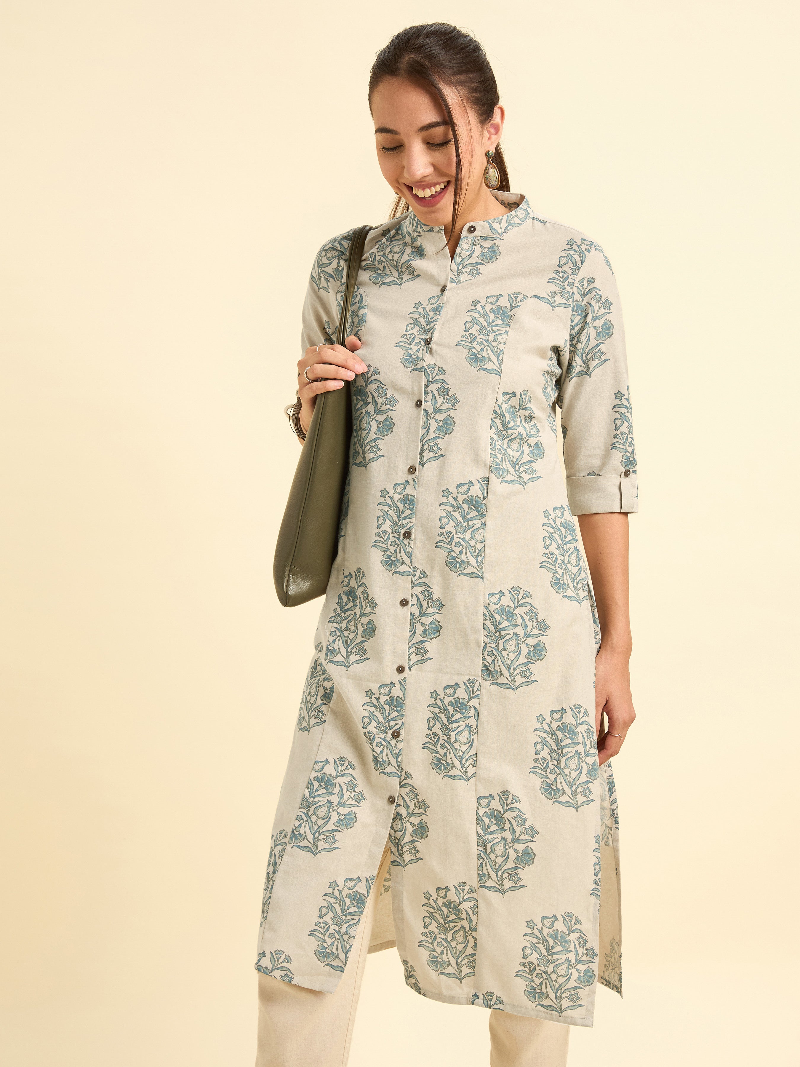 Woman wearing a floral print dress on a beige background