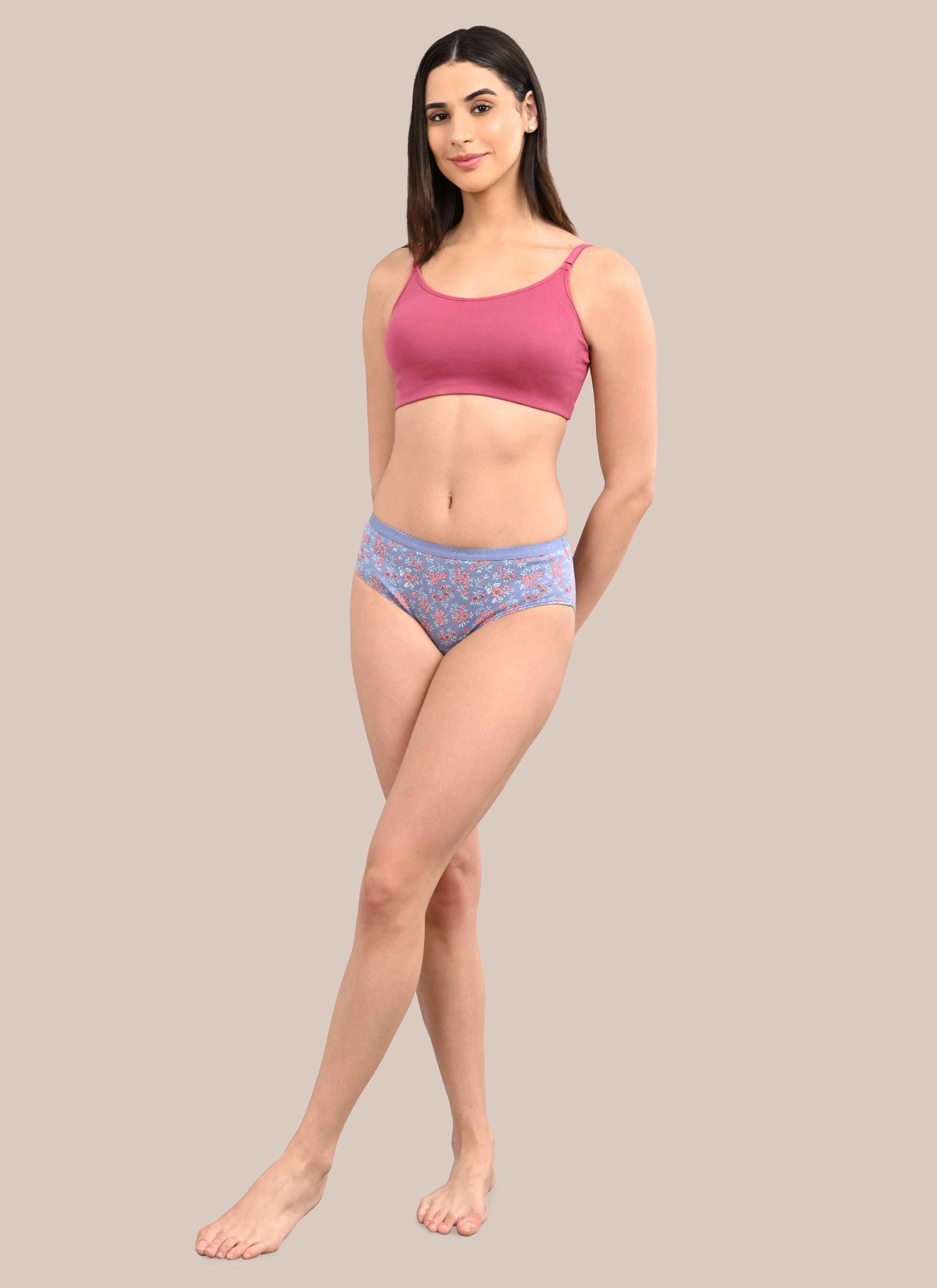 Woman wearing a bra against a neutral background