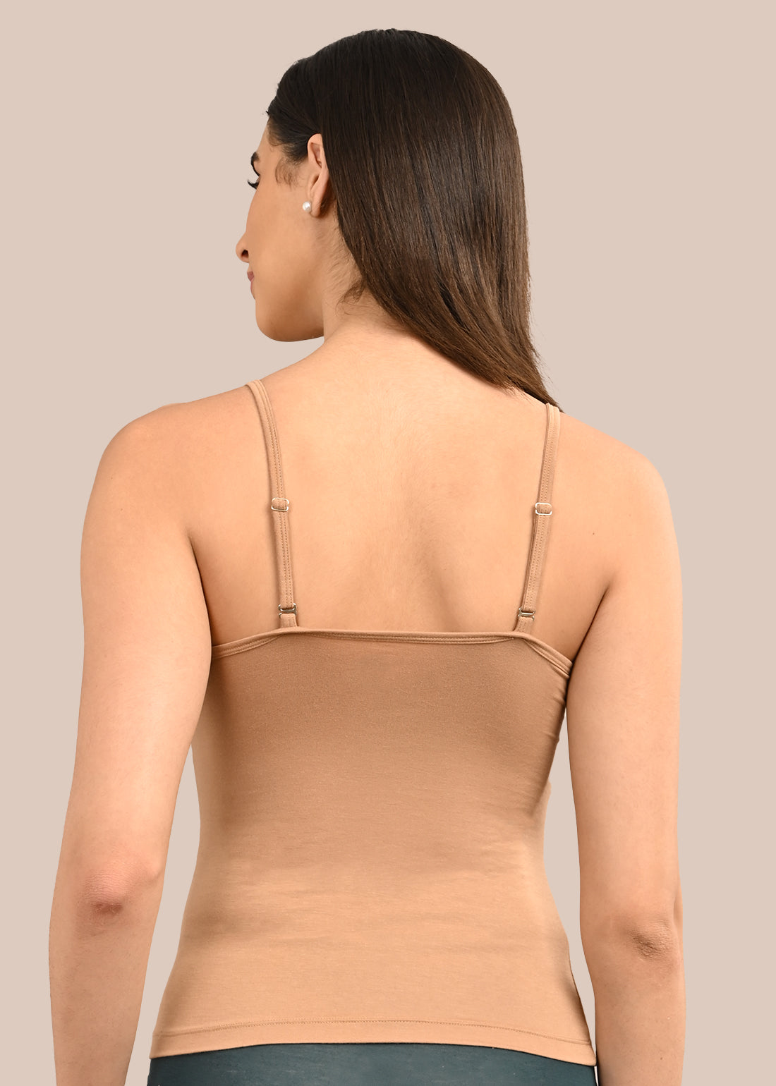 Woman wearing a bra against a neutral background