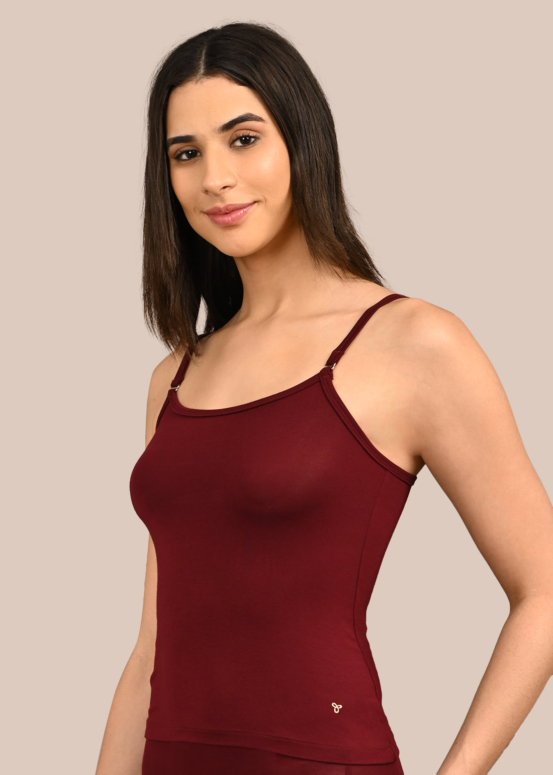 Woman wearing a bra against a neutral background