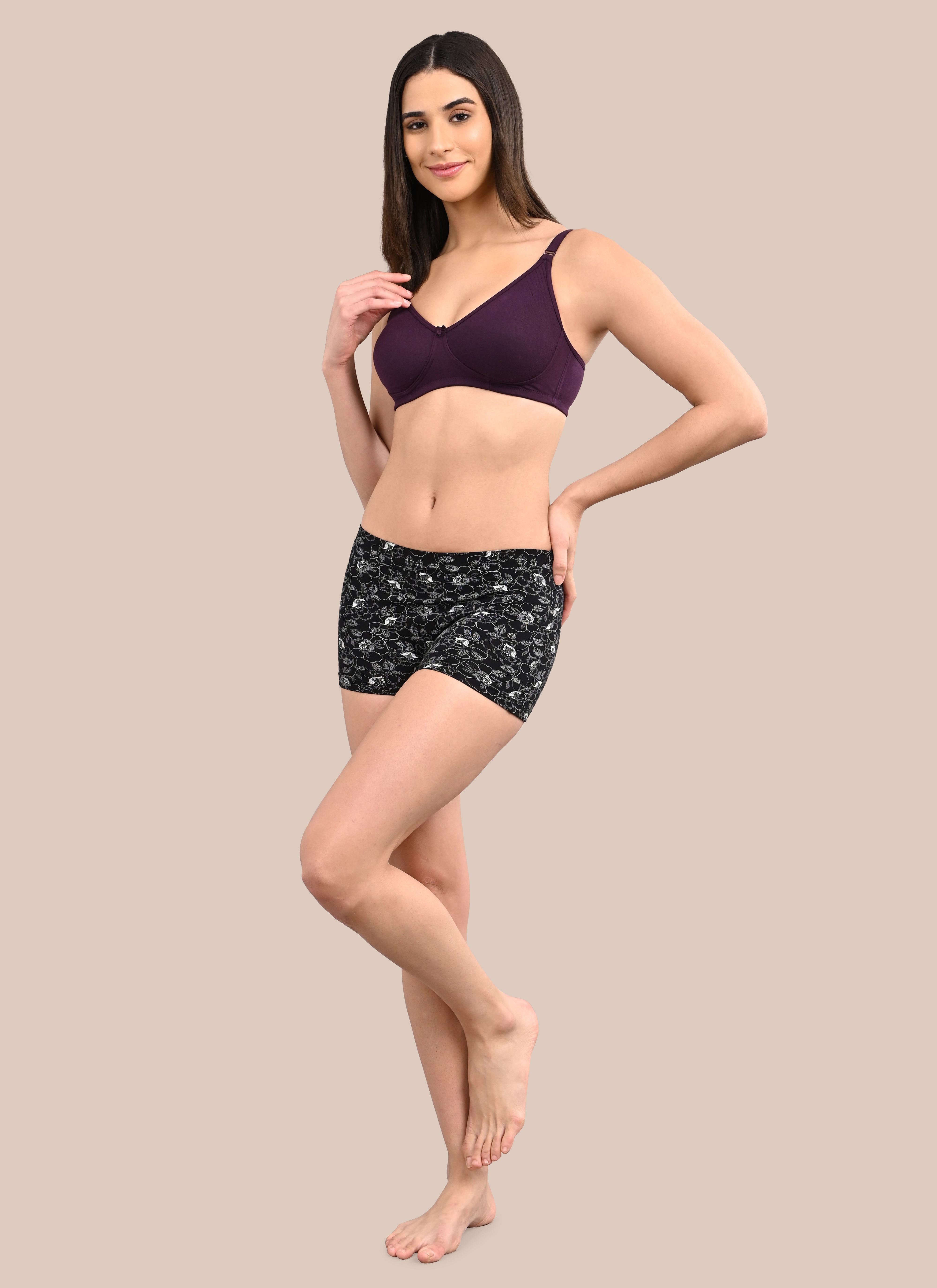 Woman wearing a bra against a neutral background