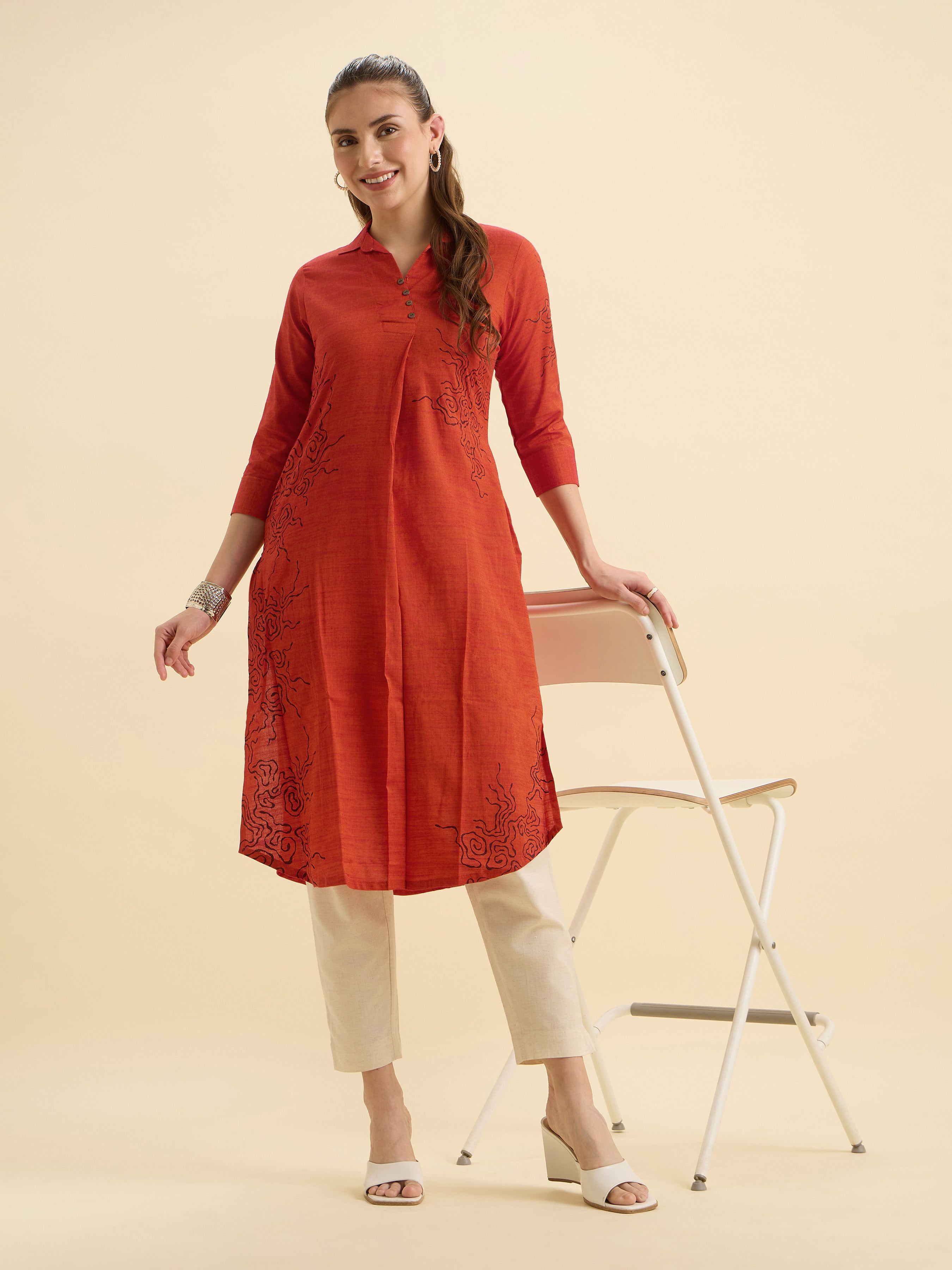 Orange Cotton Viscose Plain Slit Kurti With Placement Print, Knife Pleats & Curved Hemline