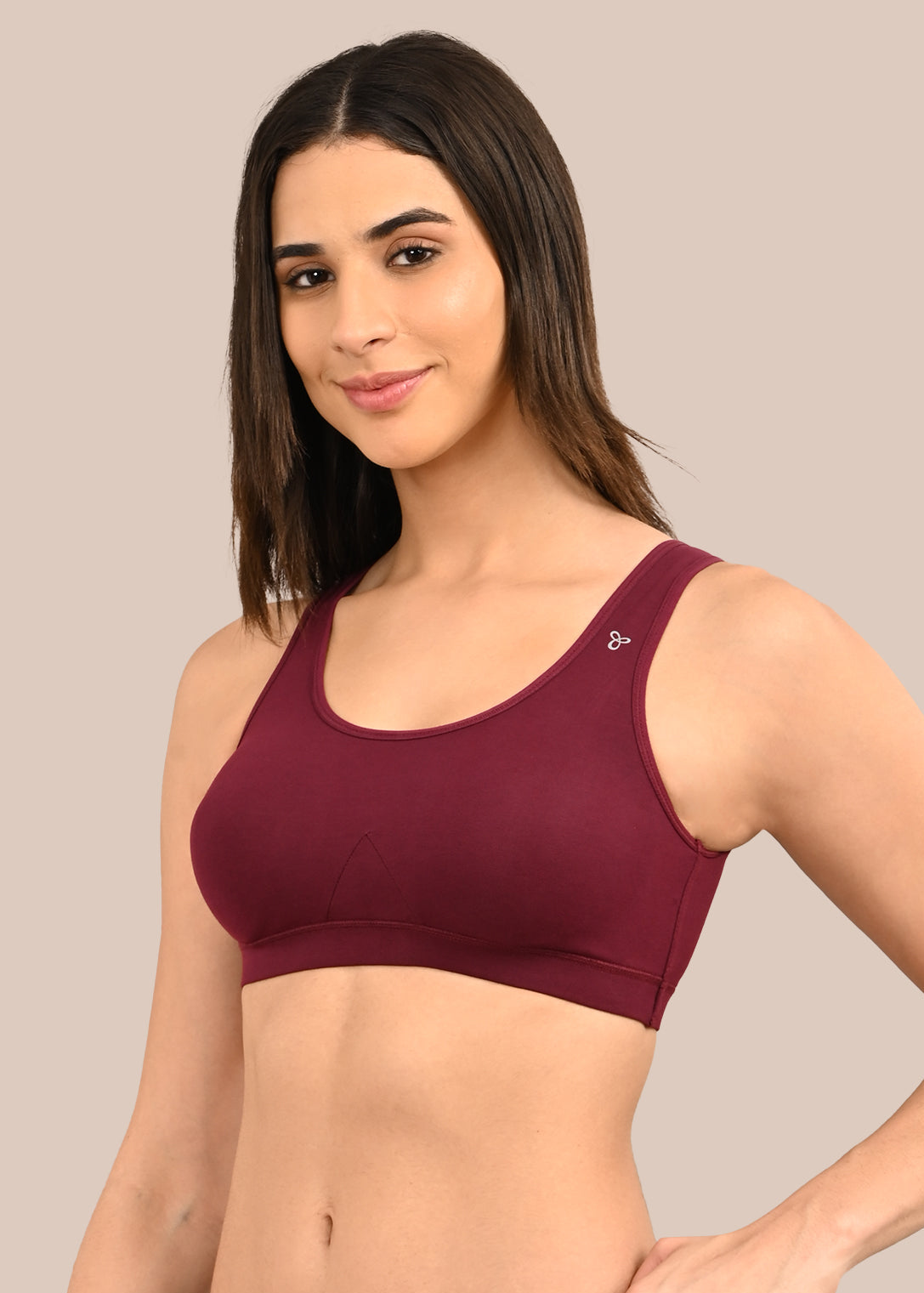 Woman wearing a bra against a neutral background