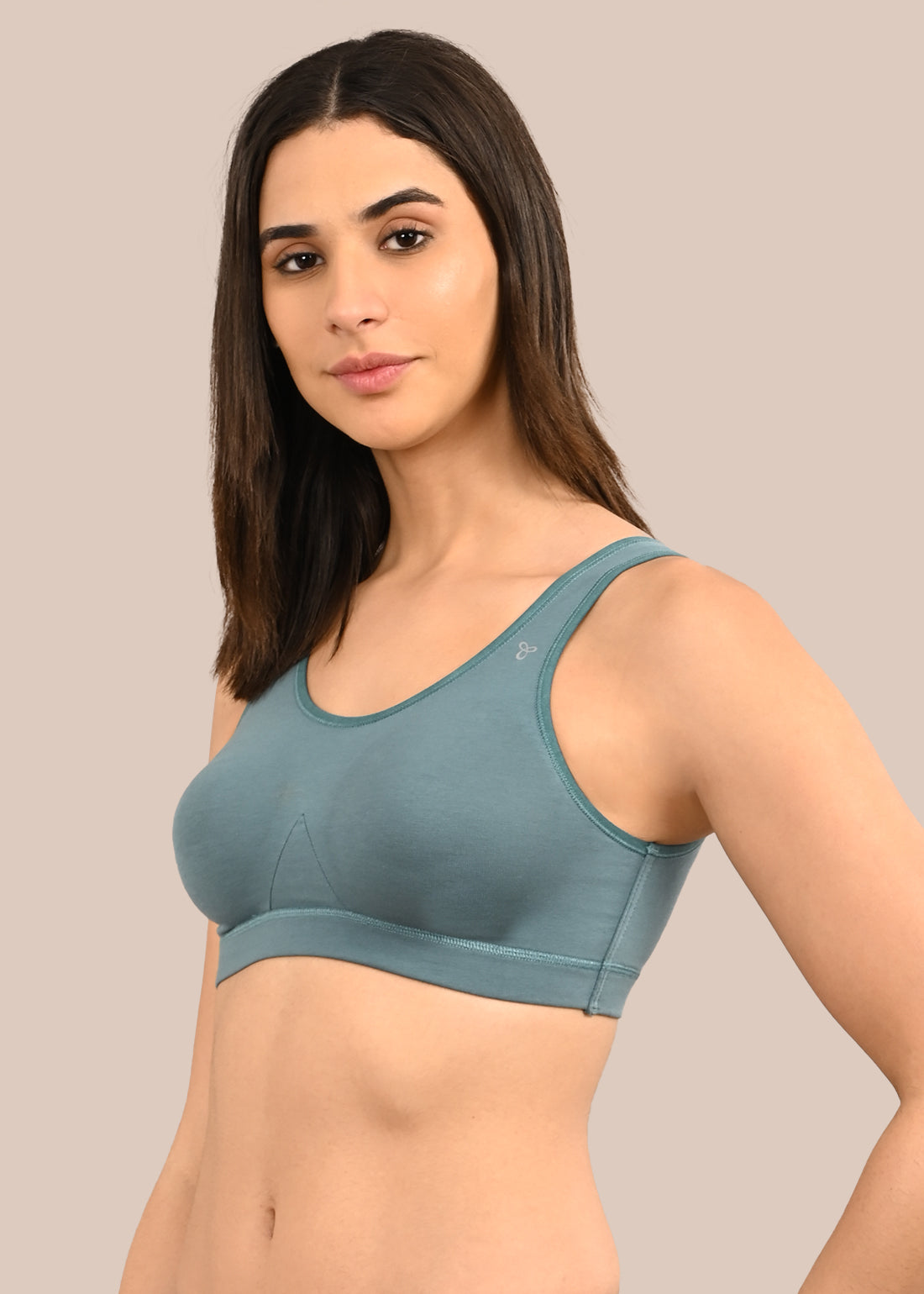 Woman wearing a bra against a neutral background